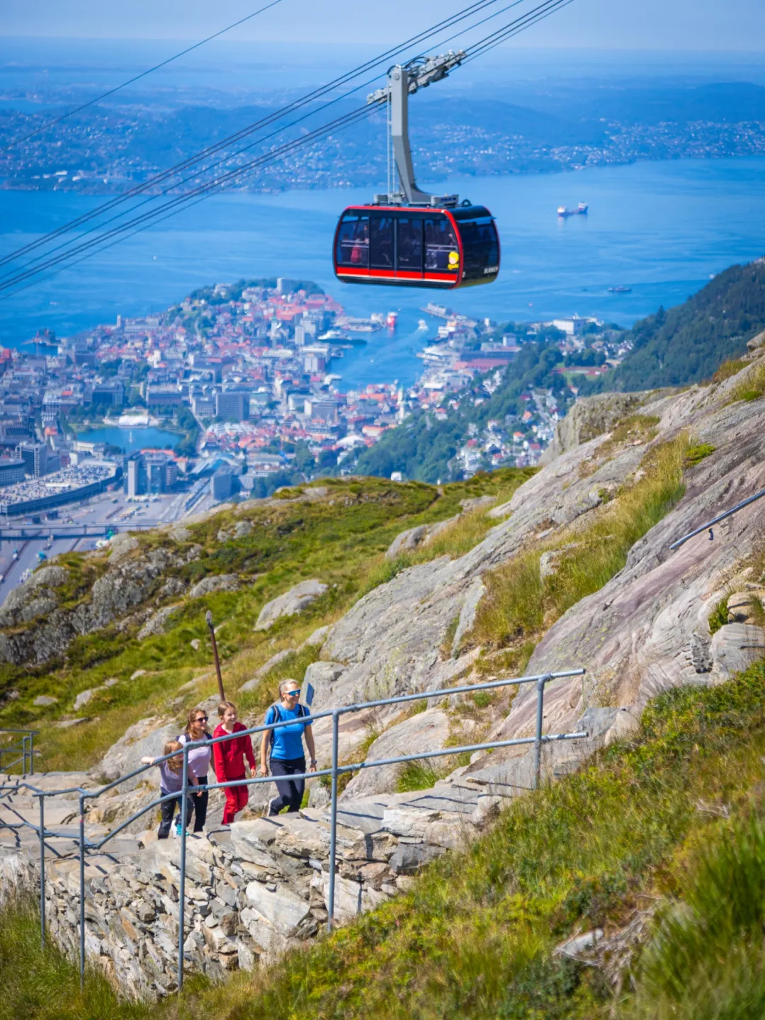 Ulriken Cable Car Shuttle Bus Image 1 a train that is sitting on the side of a mountain